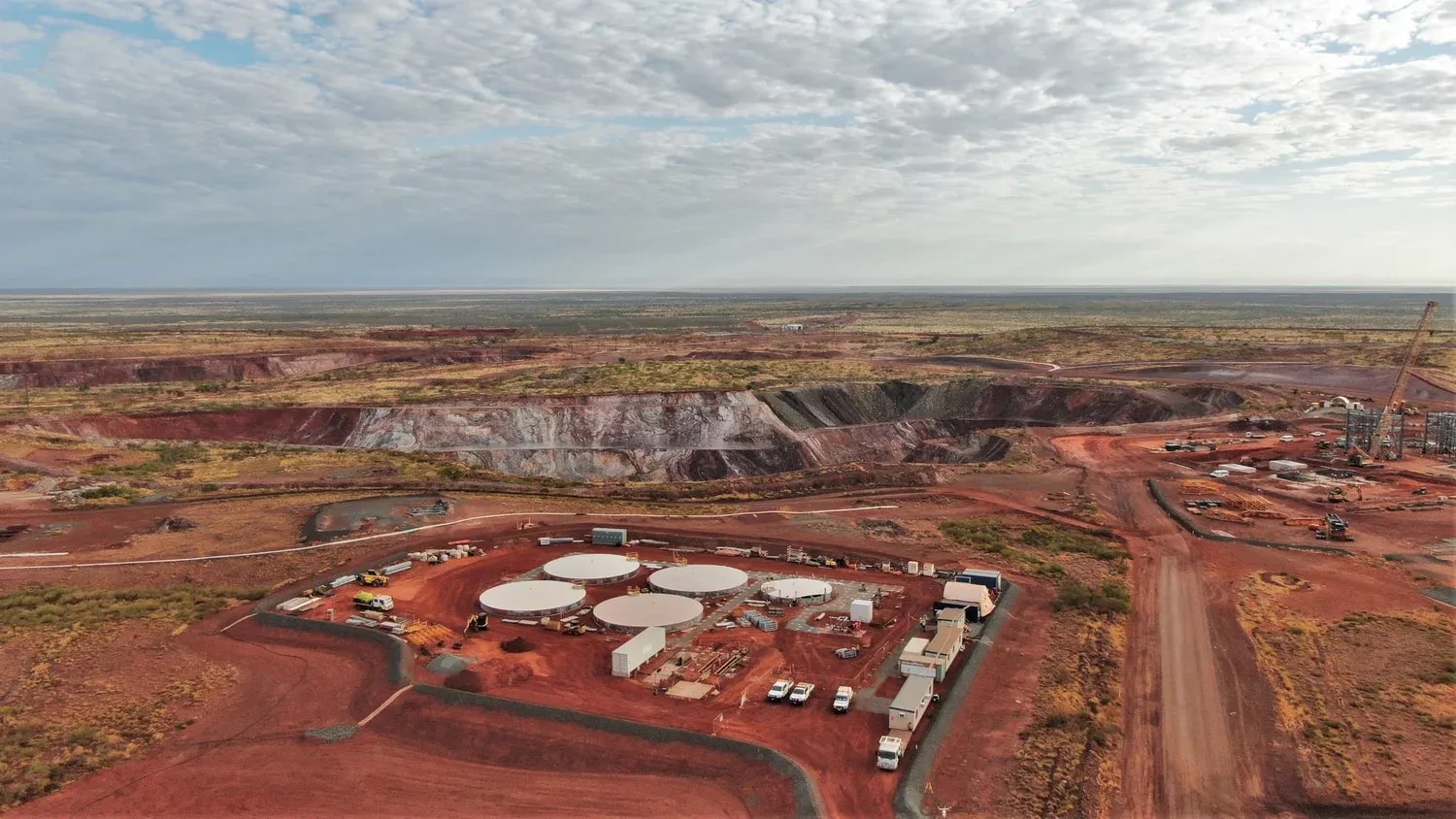 Aerial view of an open-pit mining site with terraced excavation pits